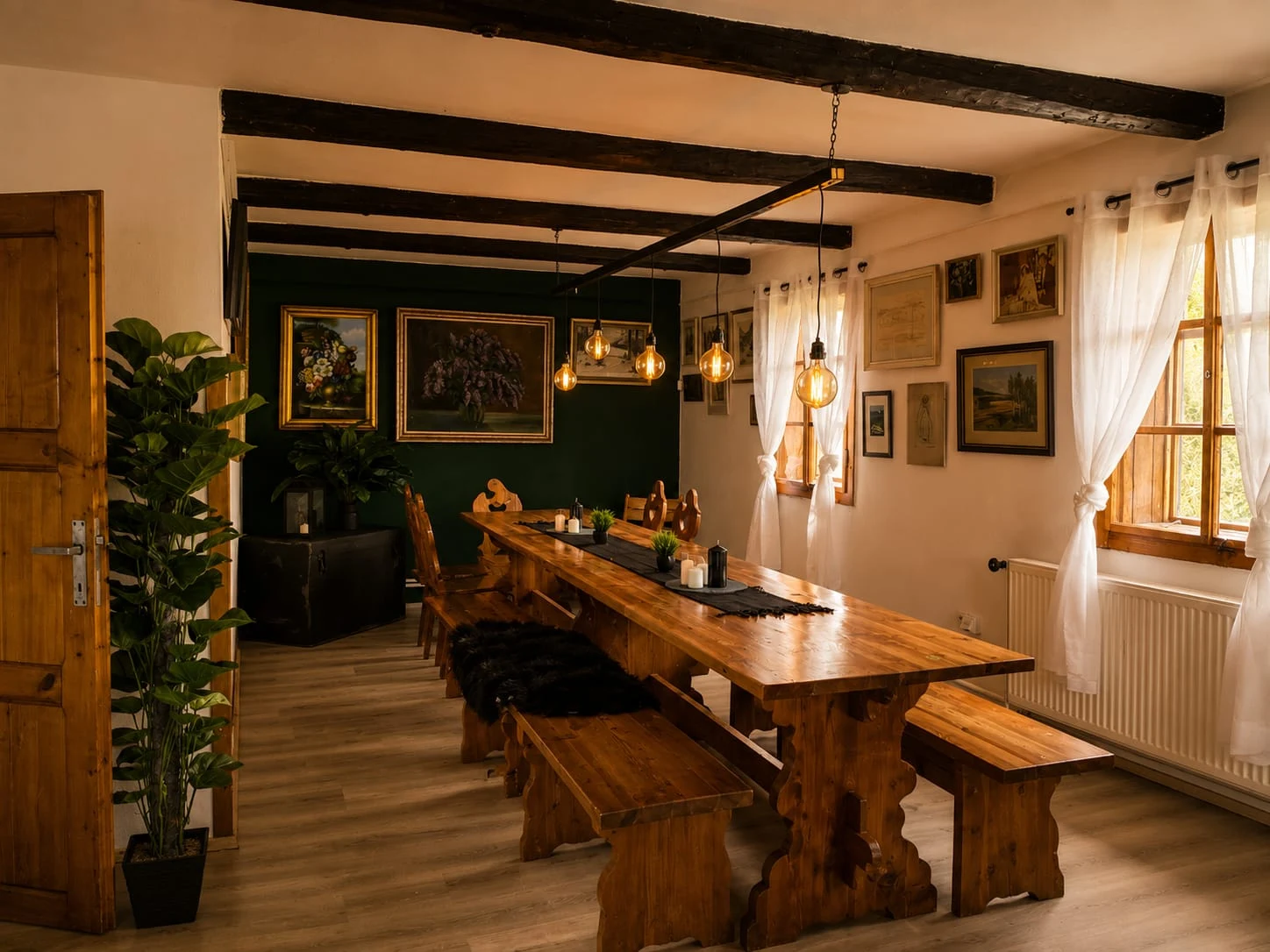 Dear Hill dining room with a long wooden table, benches, exposed ceiling beams and pendant lights.