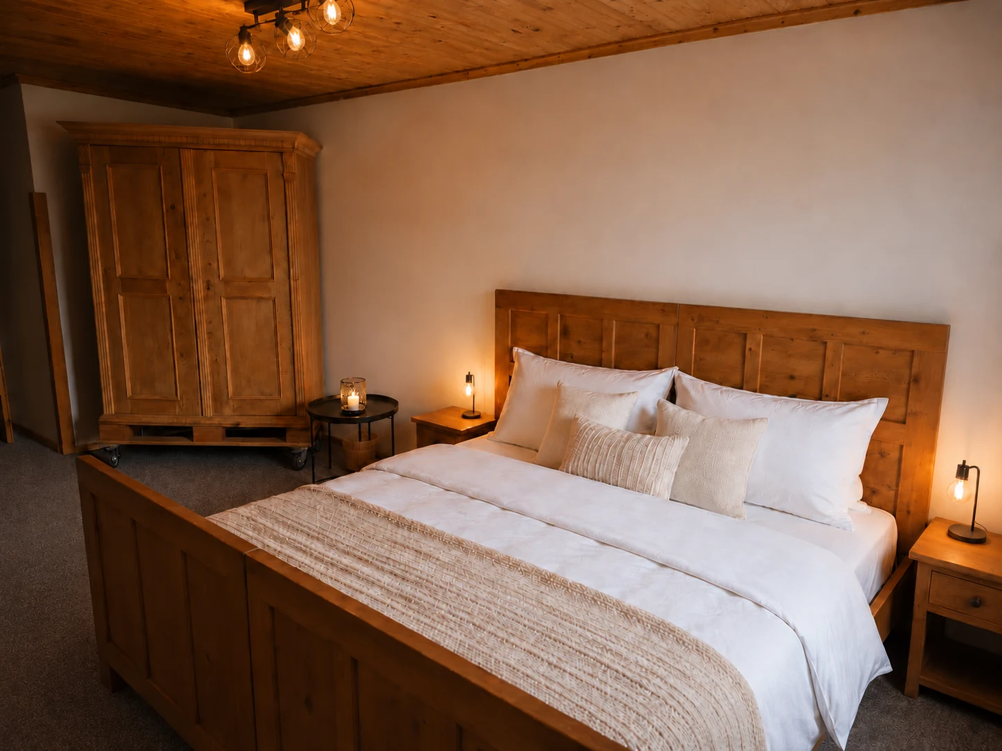 A Dear Hill guest-room double bed with wooden headboard, bedside tables and a wardrobe.