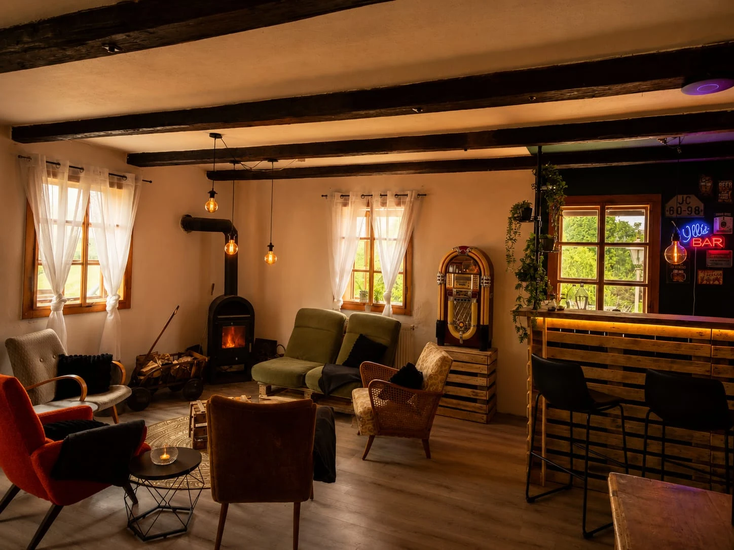 Dear Hill dining room seating area with armchairs, a wood-burning stove, jukebox and bar.